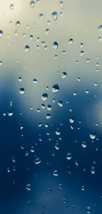 This phone live wallpaper features a stunning minimalistic close-up of water droplets on a window, taken from Shutterstock