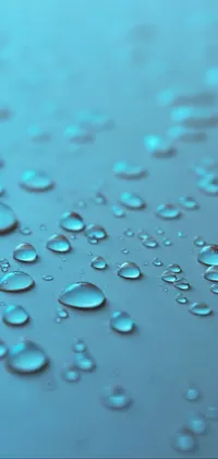 This stunning phone live wallpaper features water droplets on a blue surface