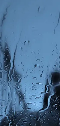 This live wallpaper for phones features a beautiful close-up window with rain droplets