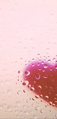 This high-resolution phone live wallpaper features a striking red heart resting upon a rain-speckled window