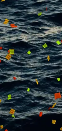 Enjoy the soothing sight of many paper pieces floating on water right on your phone with this live wallpaper