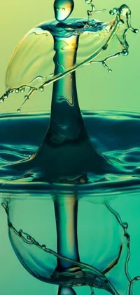This phone live wallpaper features a digital art water drop in close-up, with a vivid green background that creates a perfect contrast between the blue and green colors of the water