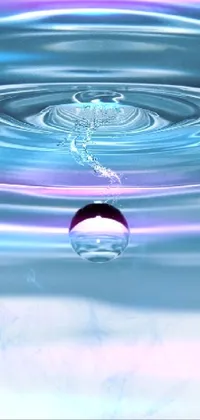 This phone live wallpaper showcases a digital rendering of a water droplet in a tranquil body of water