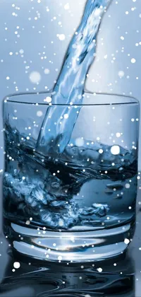 This phone live wallpaper features a glass filled with dark blue water, sitting on a table against a backdrop of a water pipe