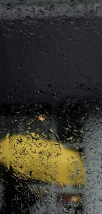 Enjoy a stunning live wallpaper for your phone featuring an umbrella in the rain
