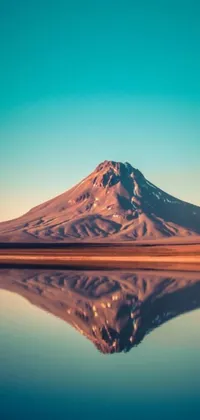 Enhance your phone's aesthetic with this stunning live wallpaper featuring a mountain reflecting in a body of water amidst a surrealistic desert backdrop in Chile
