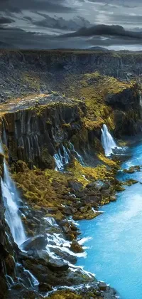 This stunning live wallpaper depicts a vast body of water resting on top of a lush green hillside, set against a forest setting in Iceland