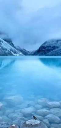 This phone live wallpaper features a breathtaking body of water surrounded by rocks in Canada