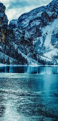 This Italy-themed phone live wallpaper features a stunning snow-covered mountain landscape surrounding a crystal clear body of water
