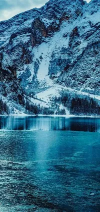 This stunning live wallpaper features a crystal-clear lake nestled at the base of a towering mountain