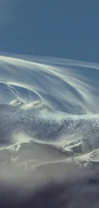 This captivating phone live wallpaper depicts a snowboarder gliding atop a snow-covered mountain slope