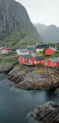 This phone live wallpaper depicts a breathtaking landscape featuring a red house sitting atop a mountain