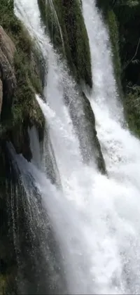 Experience the thrill of surfing on top of a majestic waterfall with this stunning live wallpaper