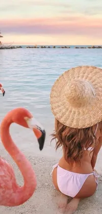 This gorgeous live wallpaper features a charming little girl sitting on a beach next to a cheerful flock of flamingos