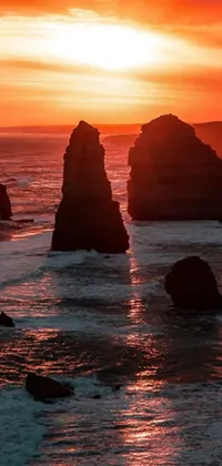 Bring the gorgeous sunset over the ocean with rocks on your phone by installing this live wallpaper