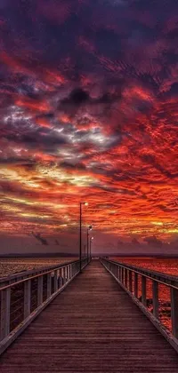 This live phone wallpaper depicts a serene pier at sunset in Australia