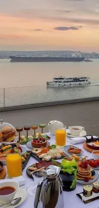 This phone live wallpaper features a table filled with scrumptious food, beautifully captured in the hurufiyya art style, against a stunning backdrop view of Istanbul
