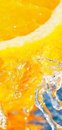 Adorn your mobile screen with this stunning phone live wallpaper featuring an orange slice submerged in sparkling water