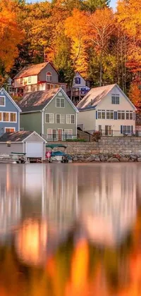 This phone live wallpaper showcases a stunning image of houses positioned near a picturesque water body