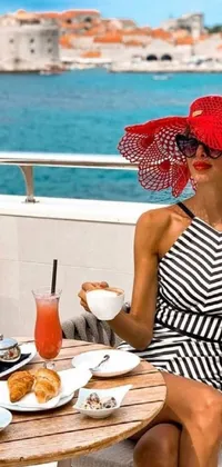 This chic and trendy phone live wallpaper features an elegant woman in a red dress and hat, holding a cup of coffee and wearing sunglasses
