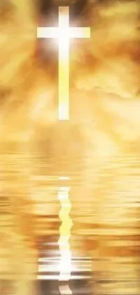 This live phone wallpaper showcases a stunning cross standing tall in the middle of calm waters