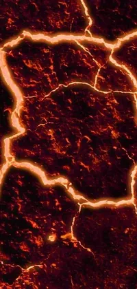 Get electrified with this stunning live phone wallpaper! Featuring a microscopic image of glowing cracks and lava made magma, the phone screen displays bolts of lightning that seem to jump out of the device