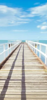 This phone live wallpaper features a peaceful view of a long wooden pier extending into the calm ocean, creating a tranquil atmosphere for your device