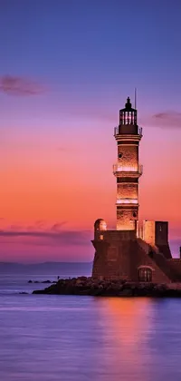 This live phone wallpaper depicts a beautiful lighthouse on the ocean at night