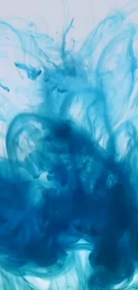 This live wallpaper showcases a mesmerizing blue substance that gently flows and swirls within a sea of water, creating bold and dynamic shapes that capture the beauty of abstract art