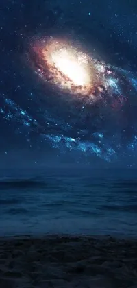 This phone live wallpaper is a breathtaking image of a galaxy in the sky, featuring stunning digital art that captures the essence of tumblr aesthetic, set against the tranquil backdrop of the sea