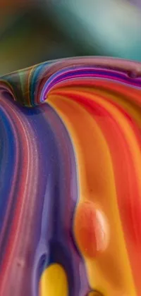This phone live wallpaper features a striking close-up of a colorful macro photograph