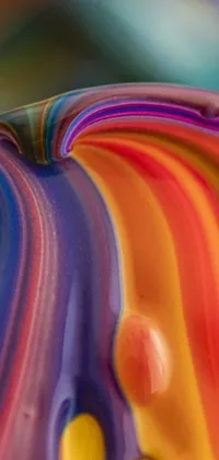 This phone live wallpaper showcases a stunning macro photograph of a colorful object on a table
