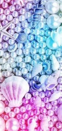 This mobile live wallpaper features a vibrant rainbow colored background complemented by pearls and seashells, purple and pink and blue neons, and crystal waters
