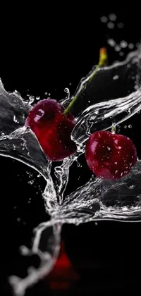 This stunning phone live wallpaper features two red cherries splashed with water droplets on a black background
