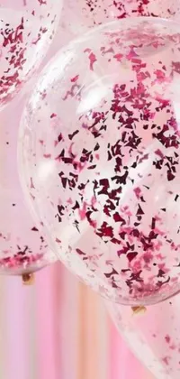 This live wallpaper features a charming display of pink balloons and confetti sprinkle on a background of blooming flowers and floating hearts