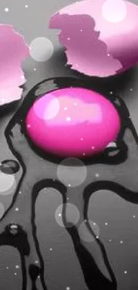 This vibrant phone live wallpaper features a pink egg resting atop a sleek black table