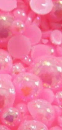 Add some color and fun to your phone with this lively phone live wallpaper! The design features a pile of cute pink beads placed on top of a table
