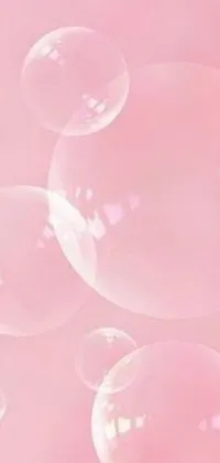 Add some color to your phone with this elegant live wallpaper featuring floating soap bubbles in shades of pastel pink and tiffany blue