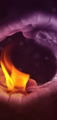 This purple fire live wallpaper showcases an intricate digital art design featuring a person holding a candle amidst swirling flames