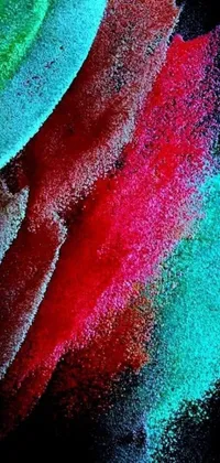 This vibrant phone live wallpaper features a close-up view of colorful powdered pigments on a black background inspired by abstract expressionist art