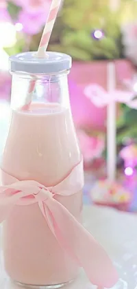 This phone live wallpaper features a realistic milk bottle and plate, surrounded by soft pink ribbons and leaves