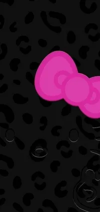 This phone live wallpaper features a playful design with a pink Hello Kitty bow on a leopard print background