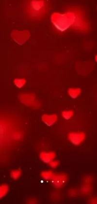 Download our stunning and romantic live wallpaper for your mobile phone today! The wallpaper features a bunch of beautiful red hearts floating in the air, creating a dreamy and ethereal ambiance on your screen