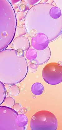 This live wallpaper features a playful display of bubbles in varying shades of purple and orange arranged in layers