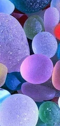 This live phone wallpaper features a stunning pile of sea glass on a table, complemented by a microscopic photo