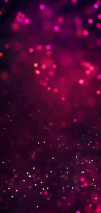 This live phone wallpaper showcases a dark background with an eye-catching display of pink lights and scattered red gems
