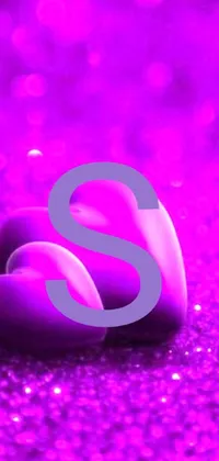 This live wallpaper for your phone showcases a unique synthetism style, featuring a couple of rocks sitting on a purple surface, accented by a glitter gif and subtle gothic heart elements