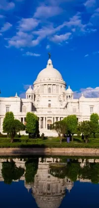 This live wallpaper features a breathtaking view of a grand and imposing white building alongside a serene body of water