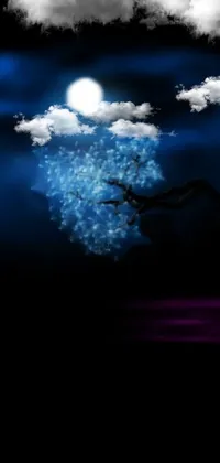 Get lost in the stunning beauty of a cherry blossom tree against a dark night sky with a stunning full moon background
