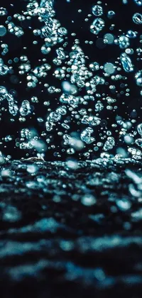 This stunning phone live wallpaper features a close-up shot of water bubbles gently moving on a surface, creating a mesmerizing effect